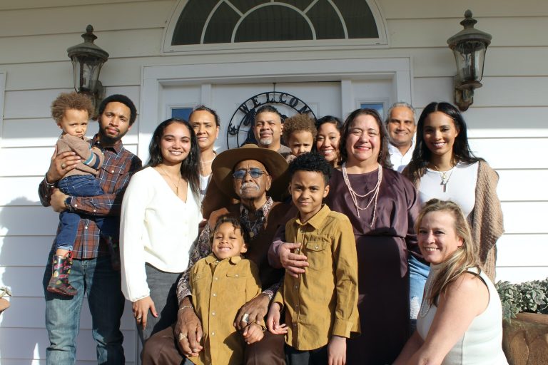 group of people standing near white building