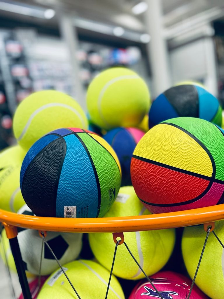 a basket full of colorful balls in a store