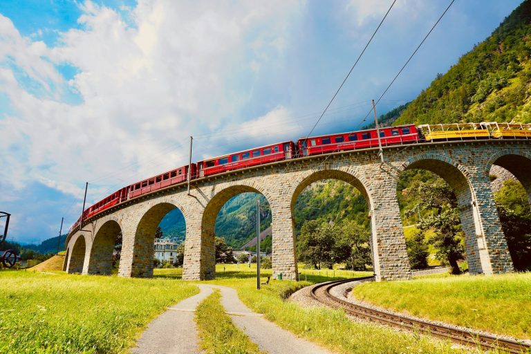 red and white bridge under cloudy sky during daytime