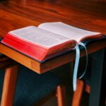 shallow focus photo of book on brown wooden table
