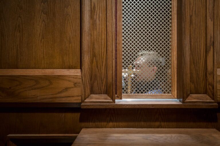 a man looking through a window in a wooden building